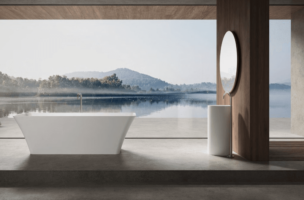 Freestanding bathtub overlooking a lake and mountains